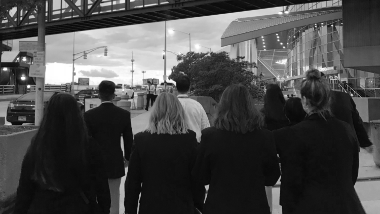 women in suits on a street
