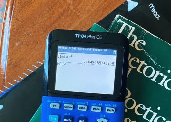 calculator and a book on a table